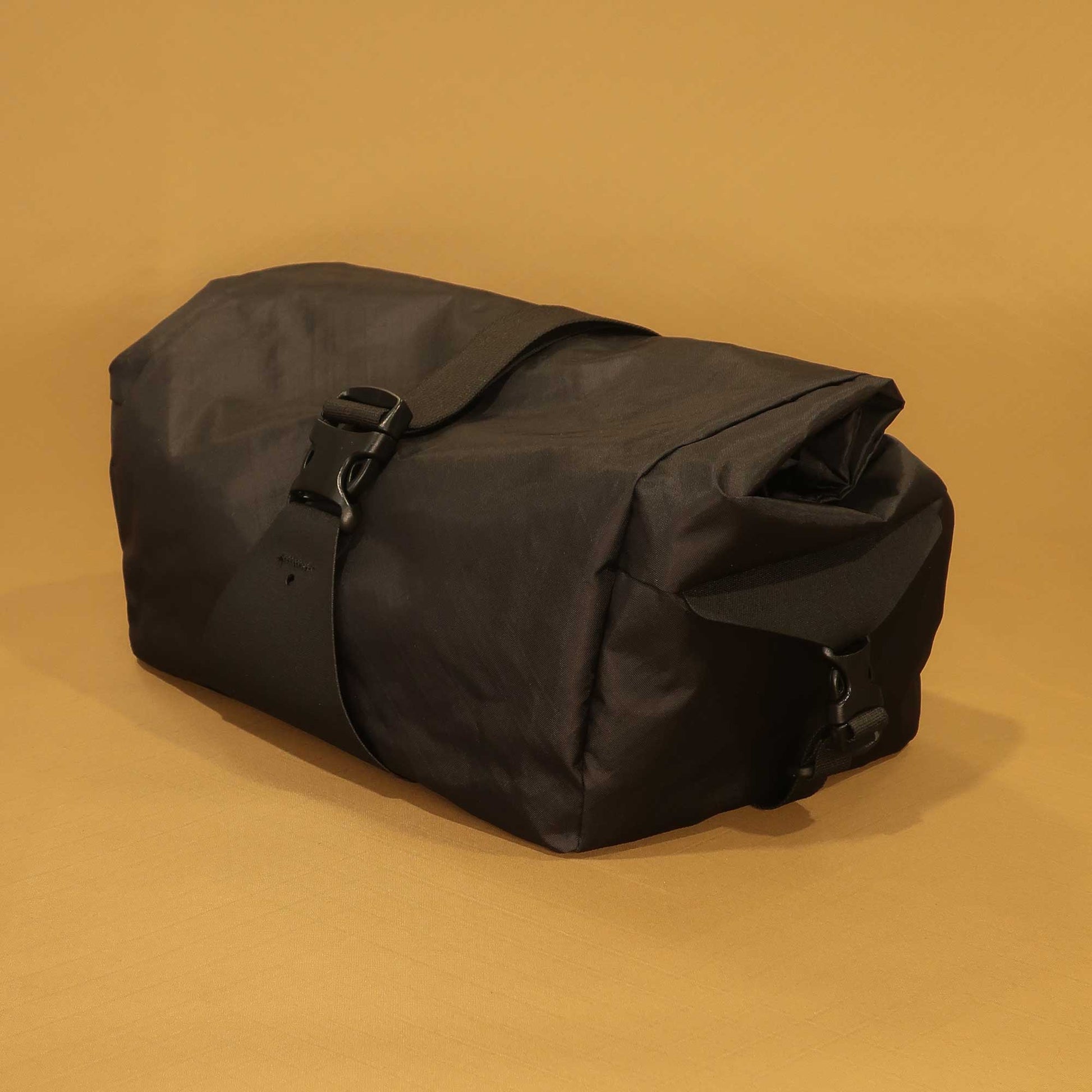 Bicycle basket bag in black EPX200 front side view with roll top and buckle made by Stealth Wellington NZ