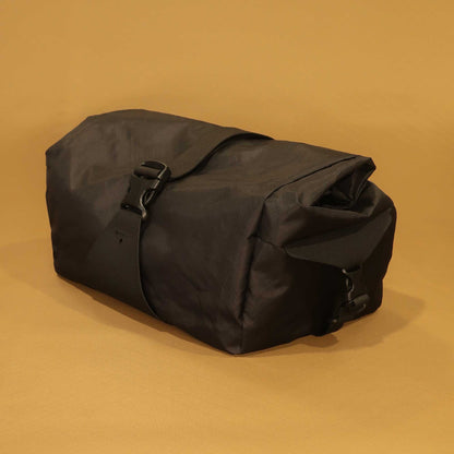 Bicycle basket bag in black EPX200 front side view with roll top and buckle made by Stealth Wellington NZ