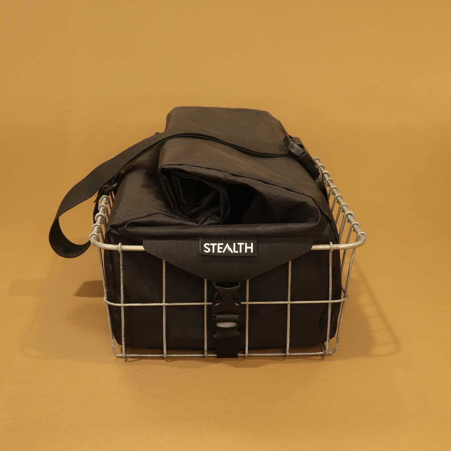 137 Carryall in black sitting in Wald basket side view showing attachments made by Stealth Wellington NZ