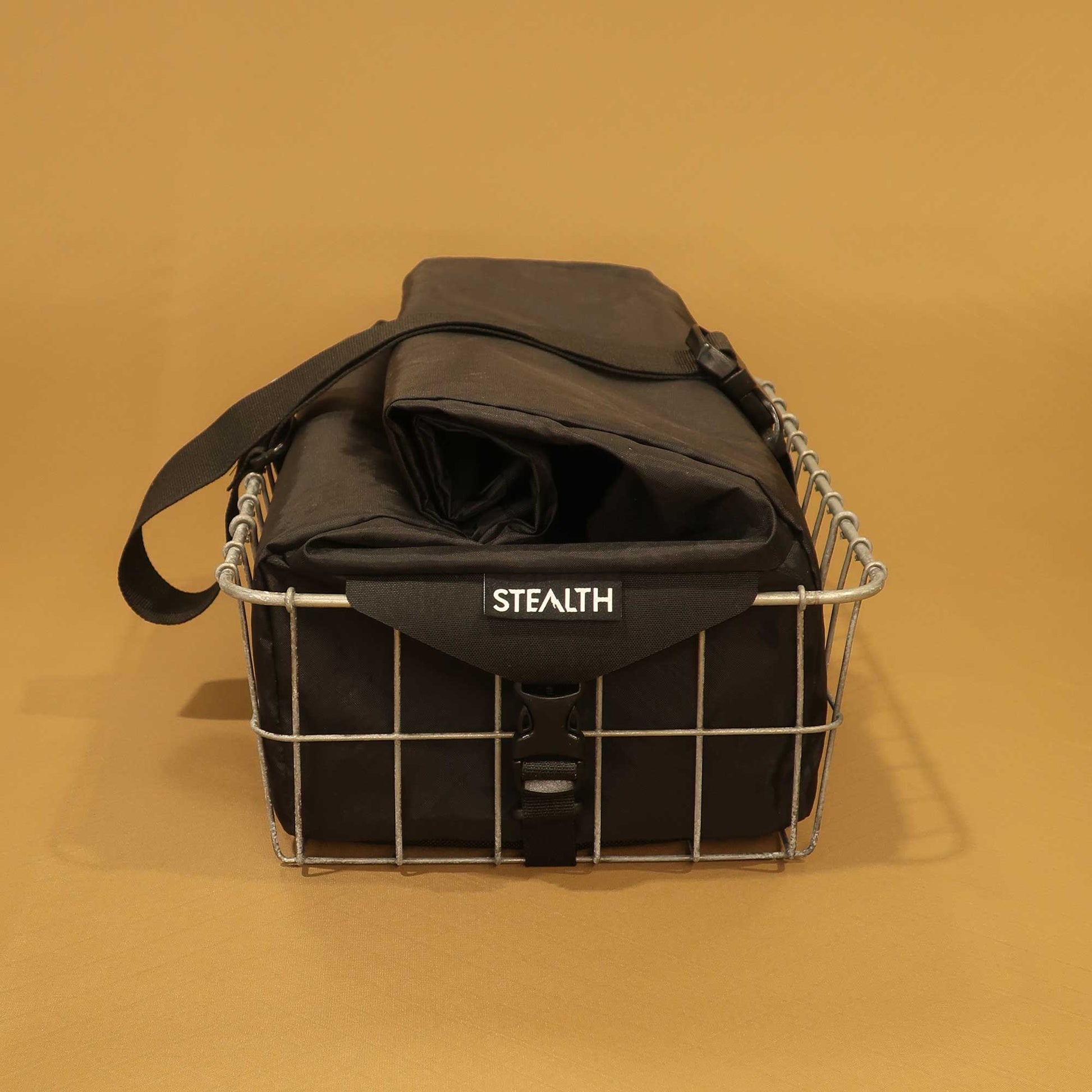 137 Carryall in black sitting in Wald basket side view showing attachments made by Stealth Wellington NZ