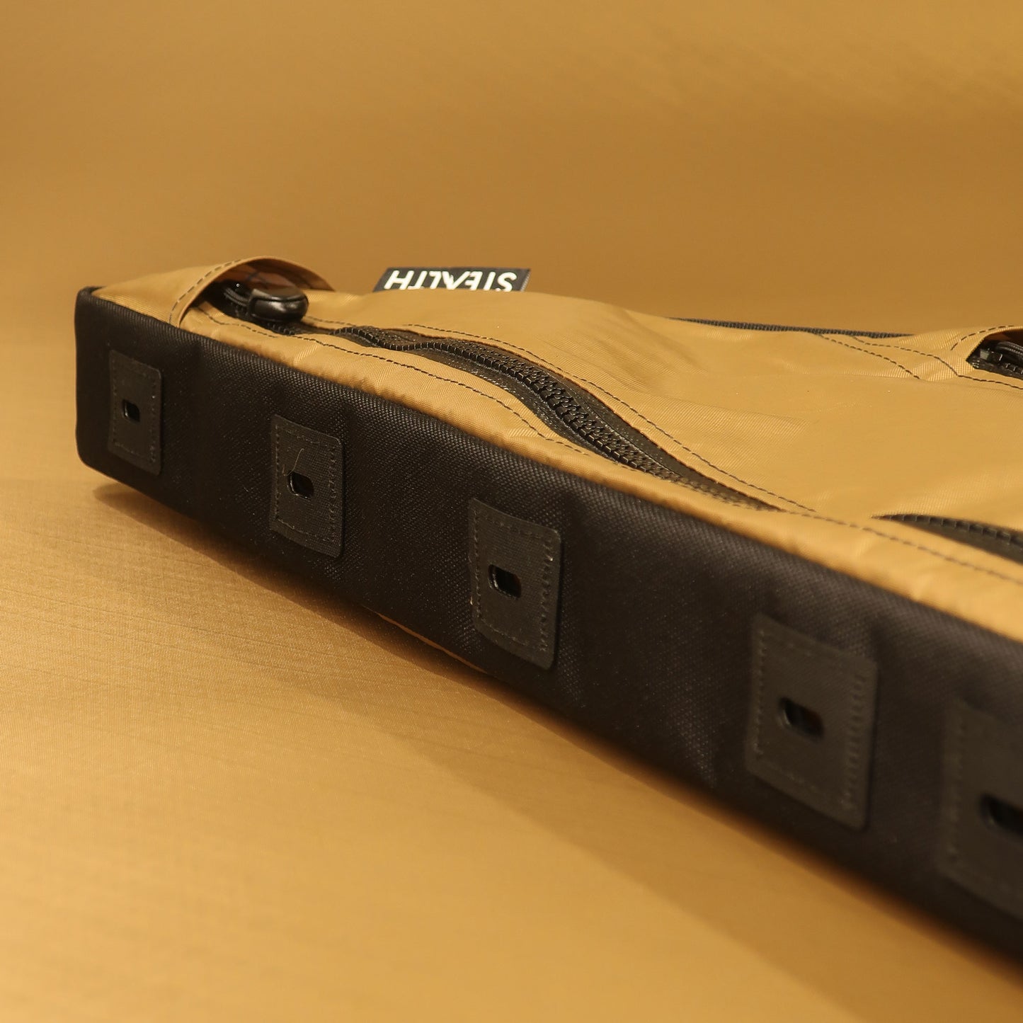 Custom handmade full frame bag with two zippers in tan and black, featuring a bolt-on attachment system and designed to fit Auren Bikes.