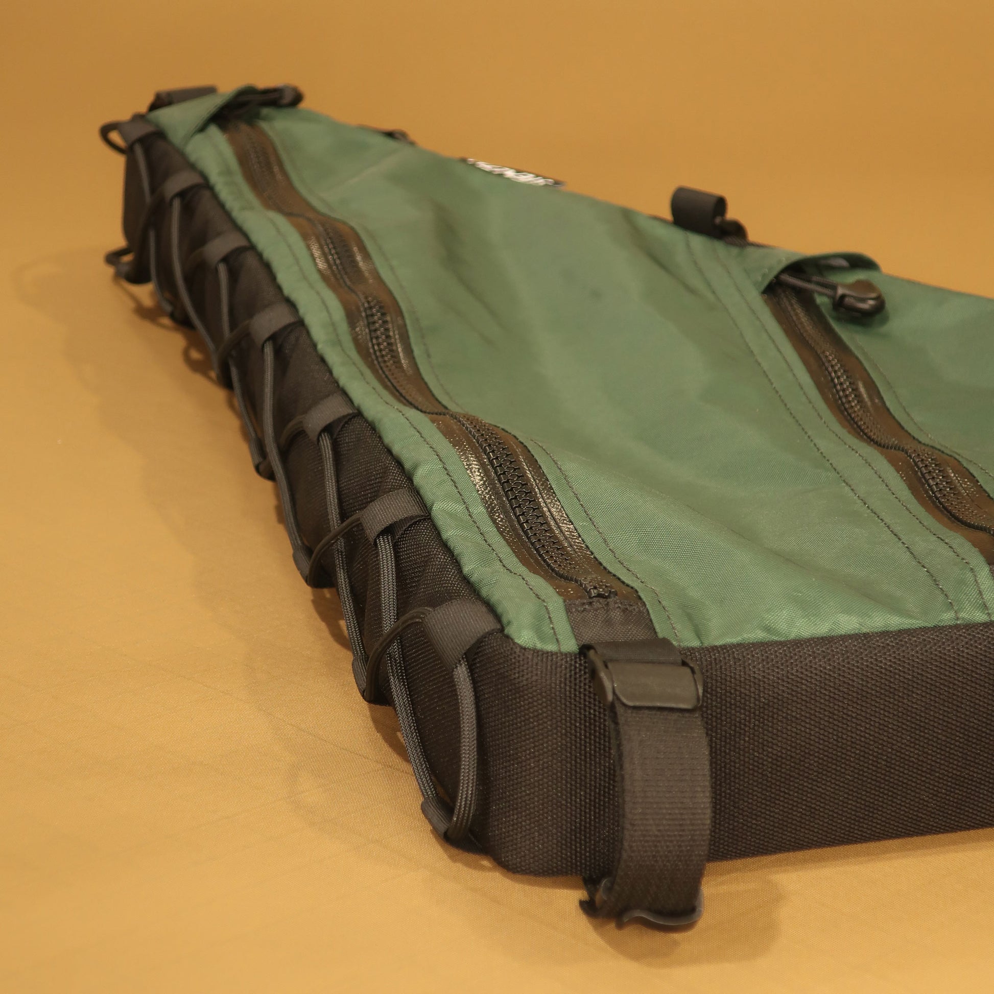Handmade Curve Uprock V2 custom frame bag for bikepacking, in green EPX200 with double zippers, lace-up and bolt-on attachment 