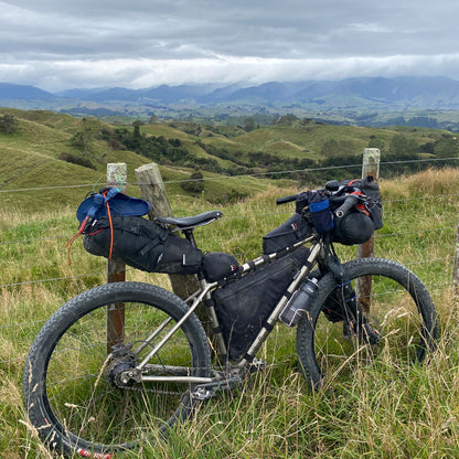 Curve custom full frame bag in black with single water-resistant zip on bikepacking setup made by Stealth Wellington NZ