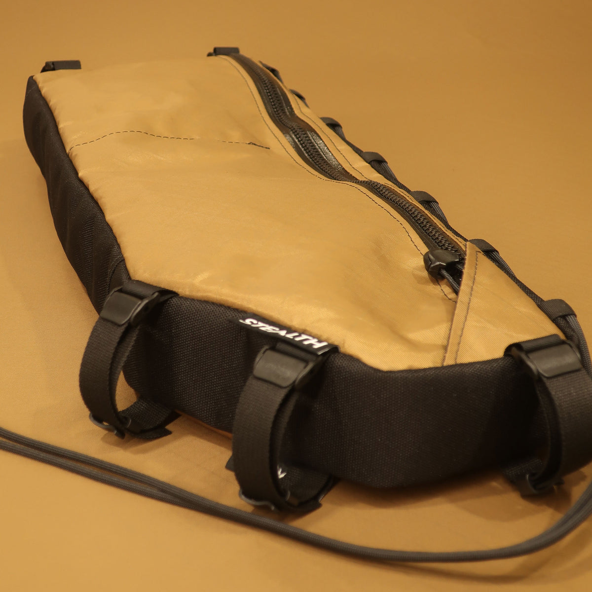 Custom coyote half frame bag with single zipper and camlock webbing straps for Kona Rove 58cm bike frame.