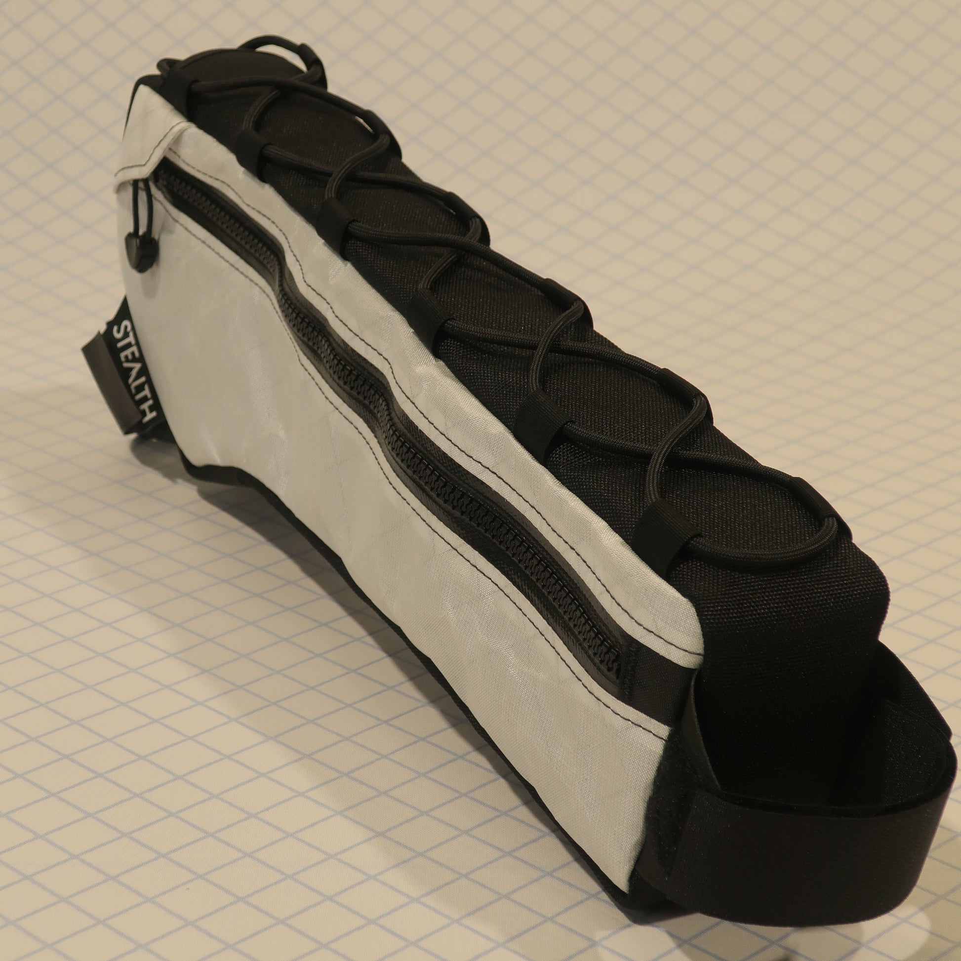 Custom half frame bag in Ultra200x fabric with single zip, lace-up, and velcro attachments for gravel bikes