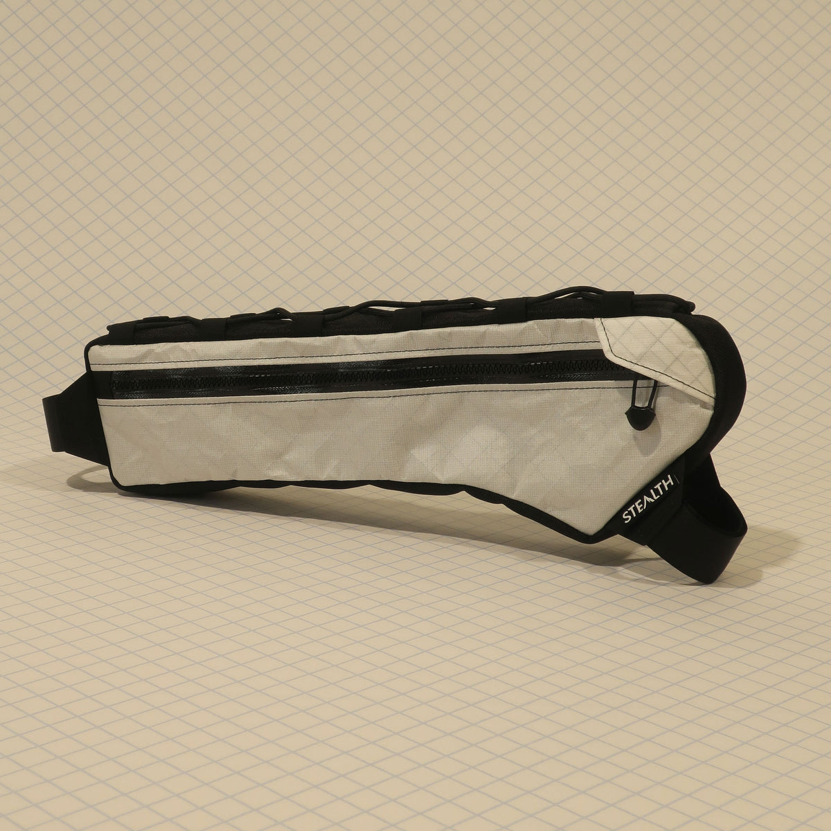 Half frame bag in light fabric with single zip, black trim, and strap, designed for gravel bikes