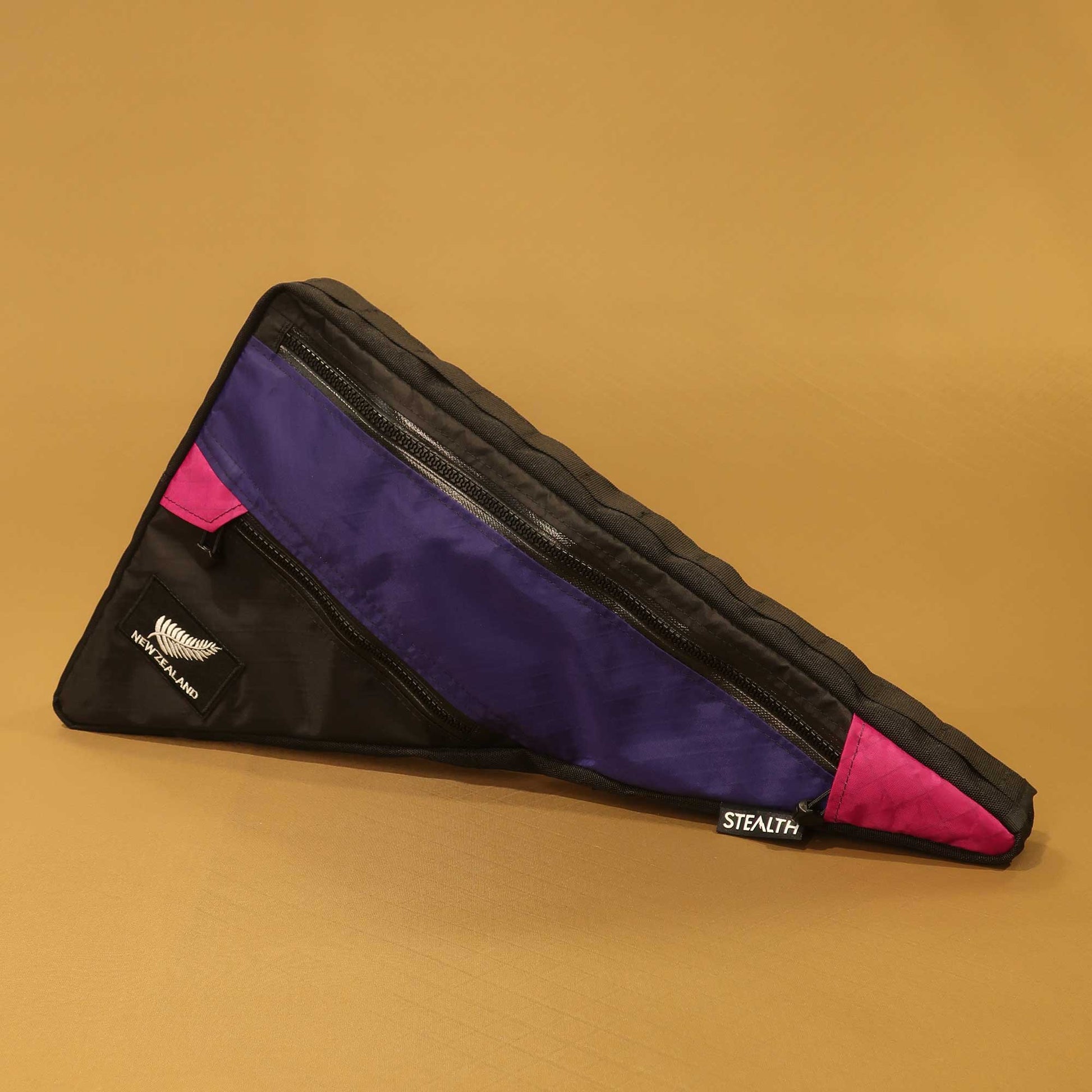 Custom frame bag in black purple and fuchsia with NZ silver fern patch and double zips made by Stealth Wellington NZ