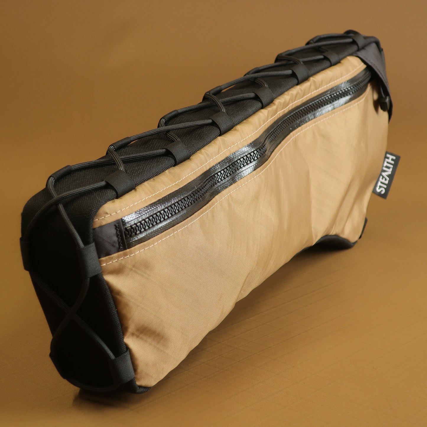 ustom half frame bag in coyote EPX200 fabric showing lace up attachment system made by Stealth Adventure Equipment Wellington NZ
