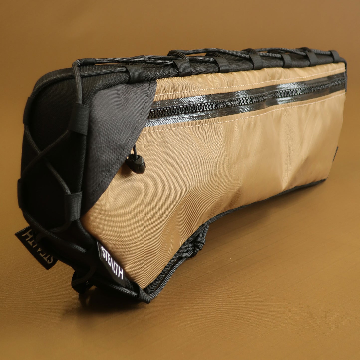 Custom half frame bag in coyote EPX200 fabric showing front zippered pocket and attachment system made by Stealth Adventure Equipment Wellington NZ