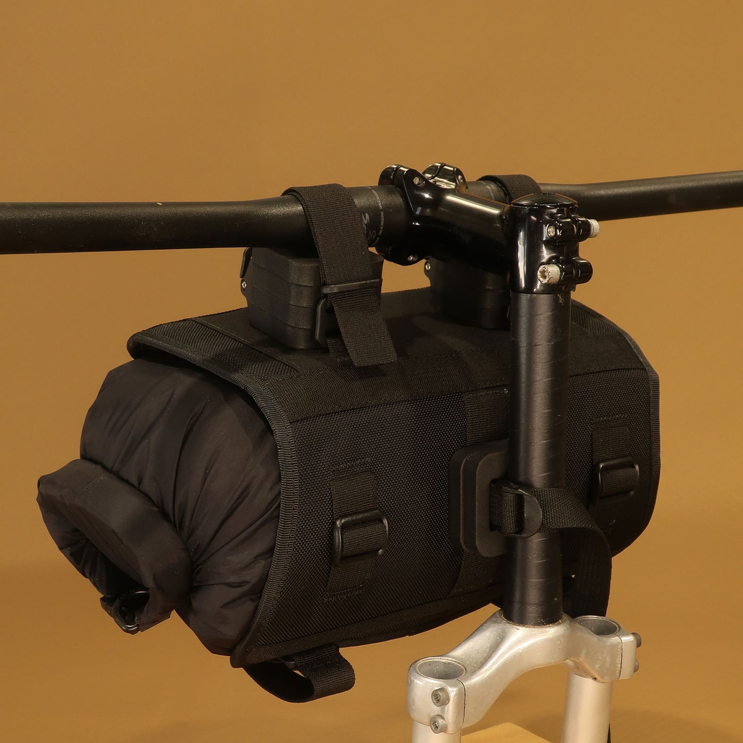 Heaphy handlebar harness loaded with dry bag viewed from rear on handlebars made by Stealth Wellington NZ