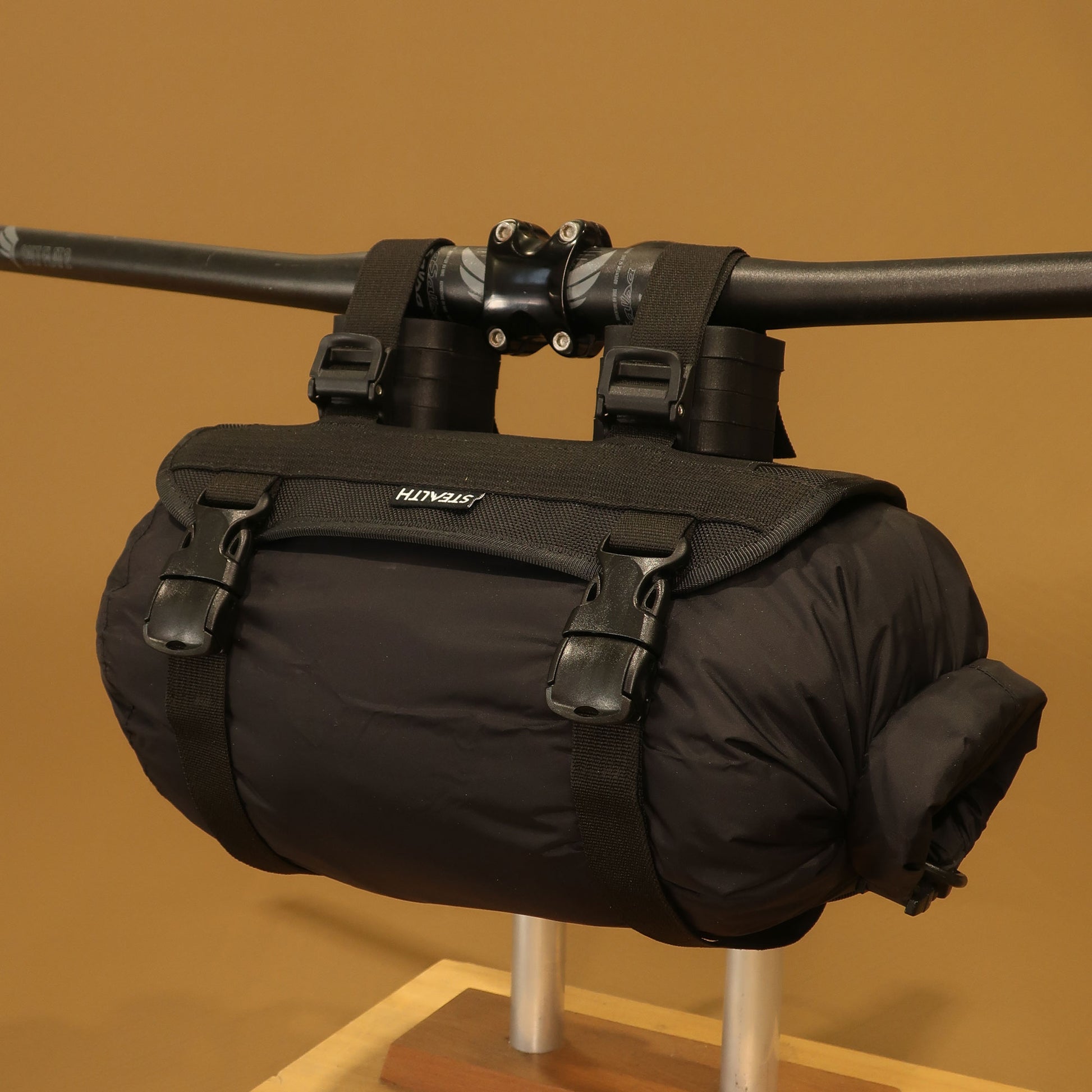 Heaphy handlebar harness loaded with sleeping bag roll mounted on bike bars made by Stealth Wellington NZ