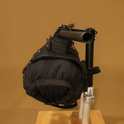 Bikepacking handlebar harness side view fully loaded with sleeping bag on bike made by Stealth Wellington NZ