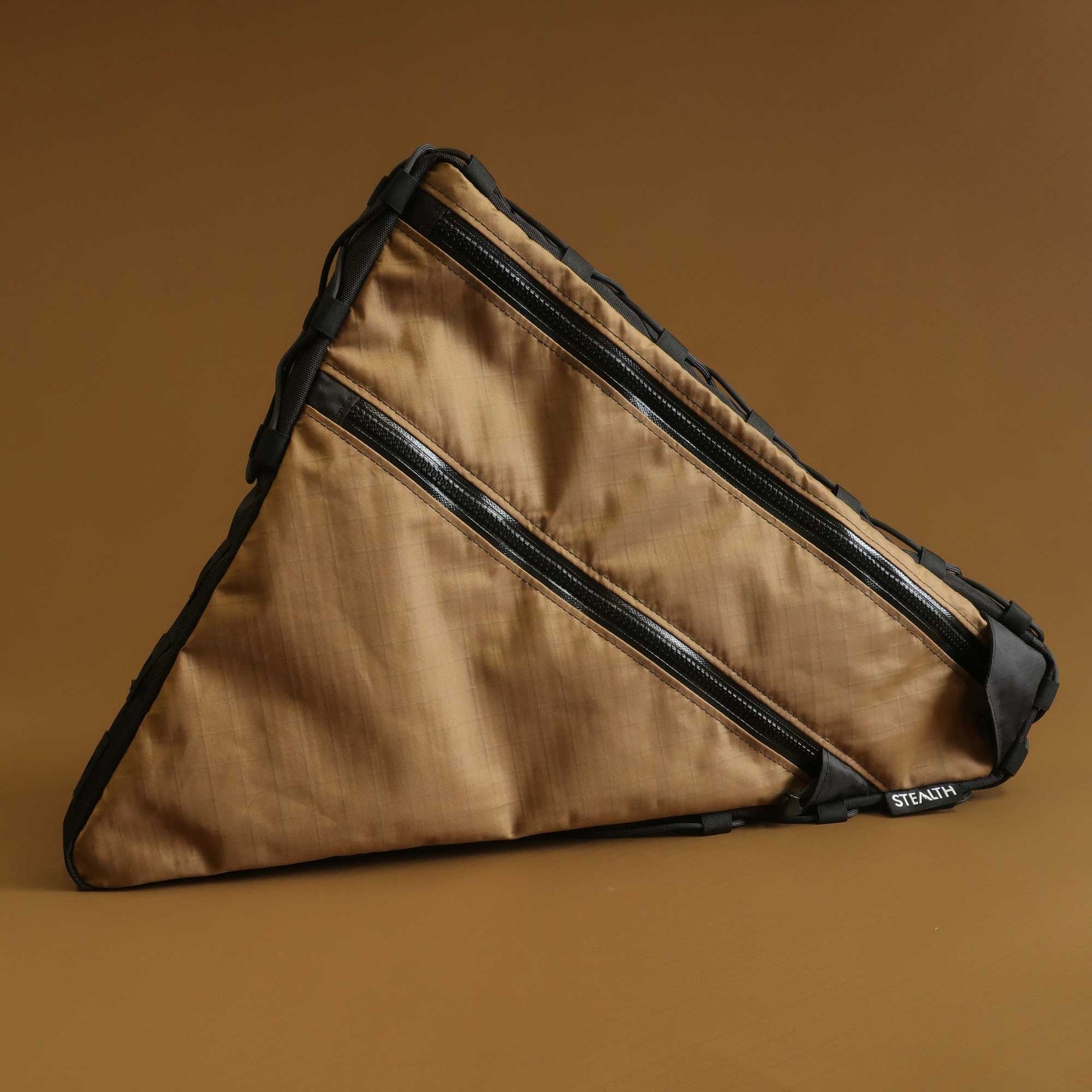 Custom gravel bike frame bag in coyote Ecopak with bolt-on and lace-up attachment made by Stealth Wellington NZ