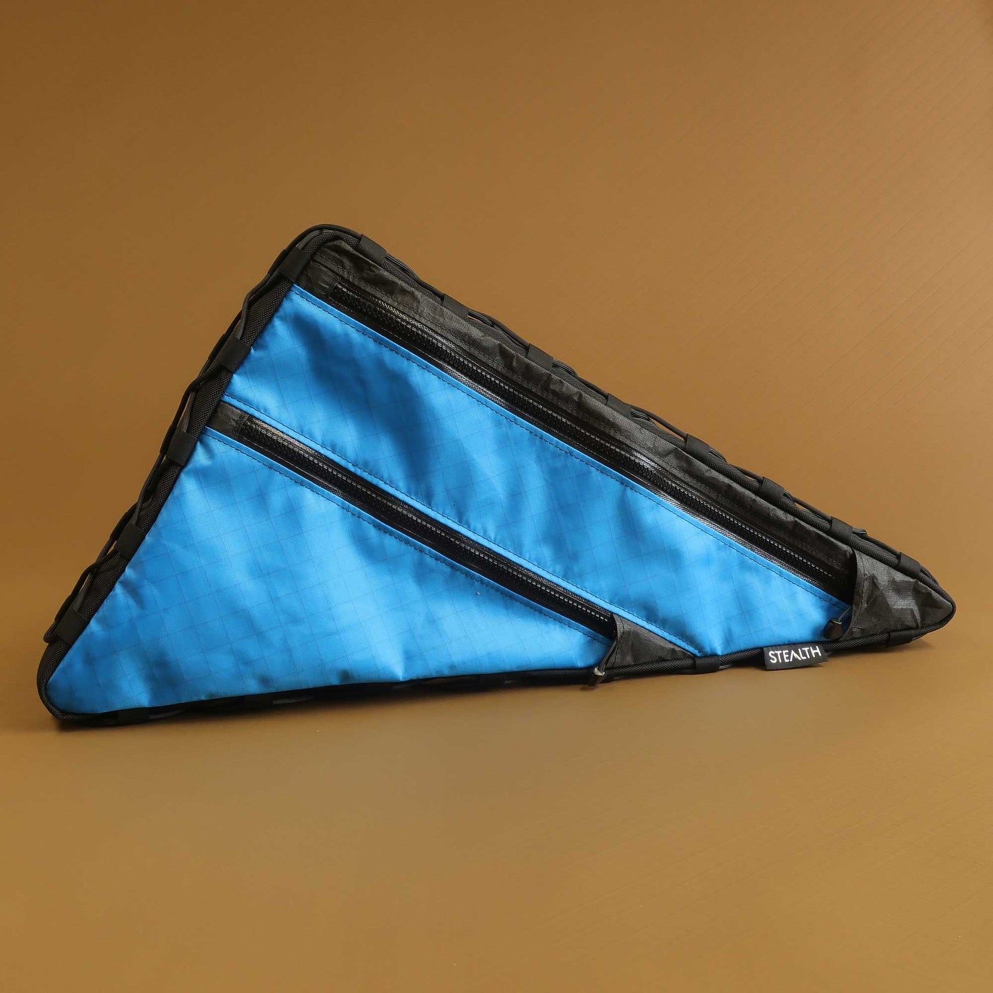 Custom bikepacking frame bag in bright blue Ultra200 with black accents and lace-up attachment made by Stealth Wellington NZ