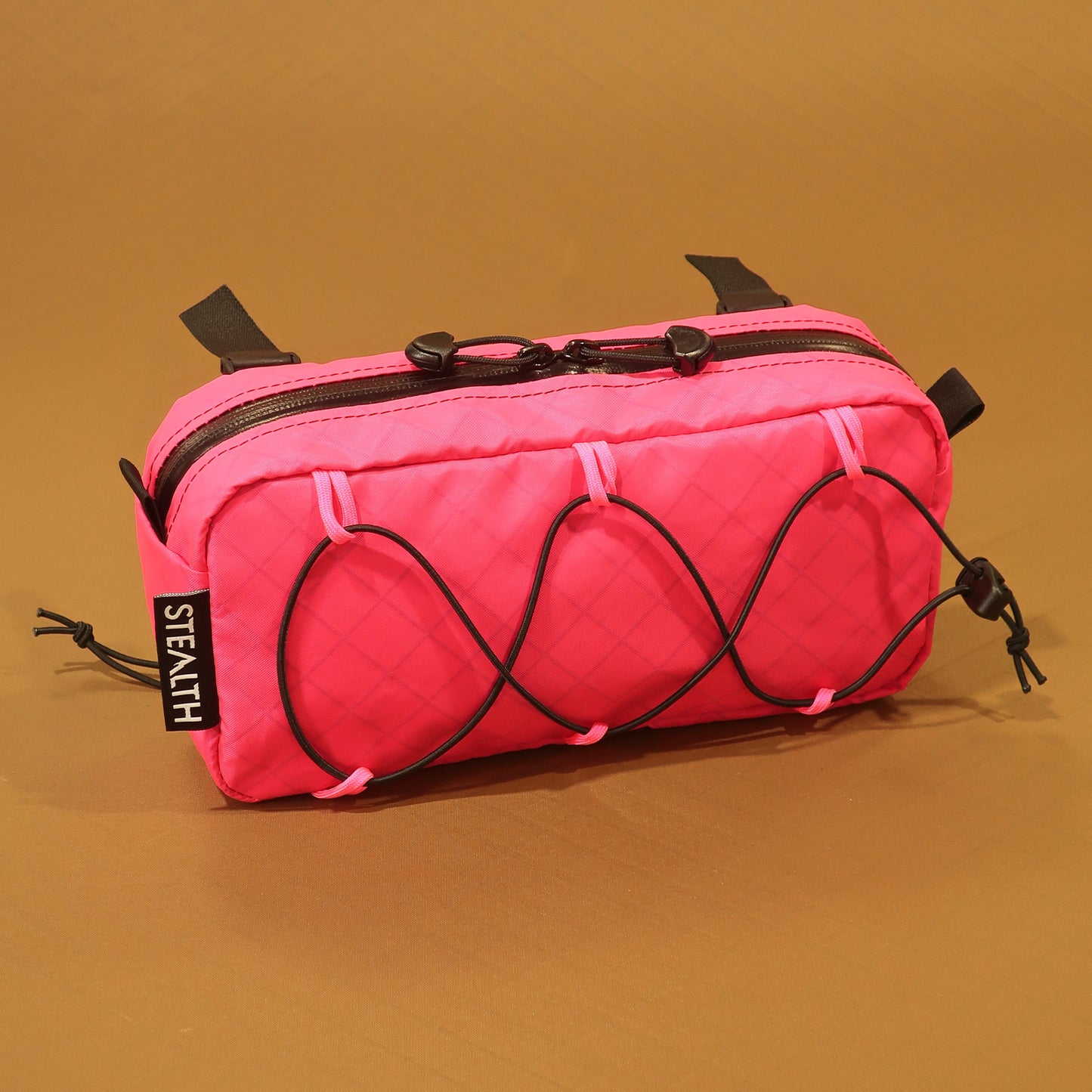Limpet bumbag in pink flamingo EPX200 showing bungee front pocket and camlock handlebar straps made by Stealth Wellington NZ
