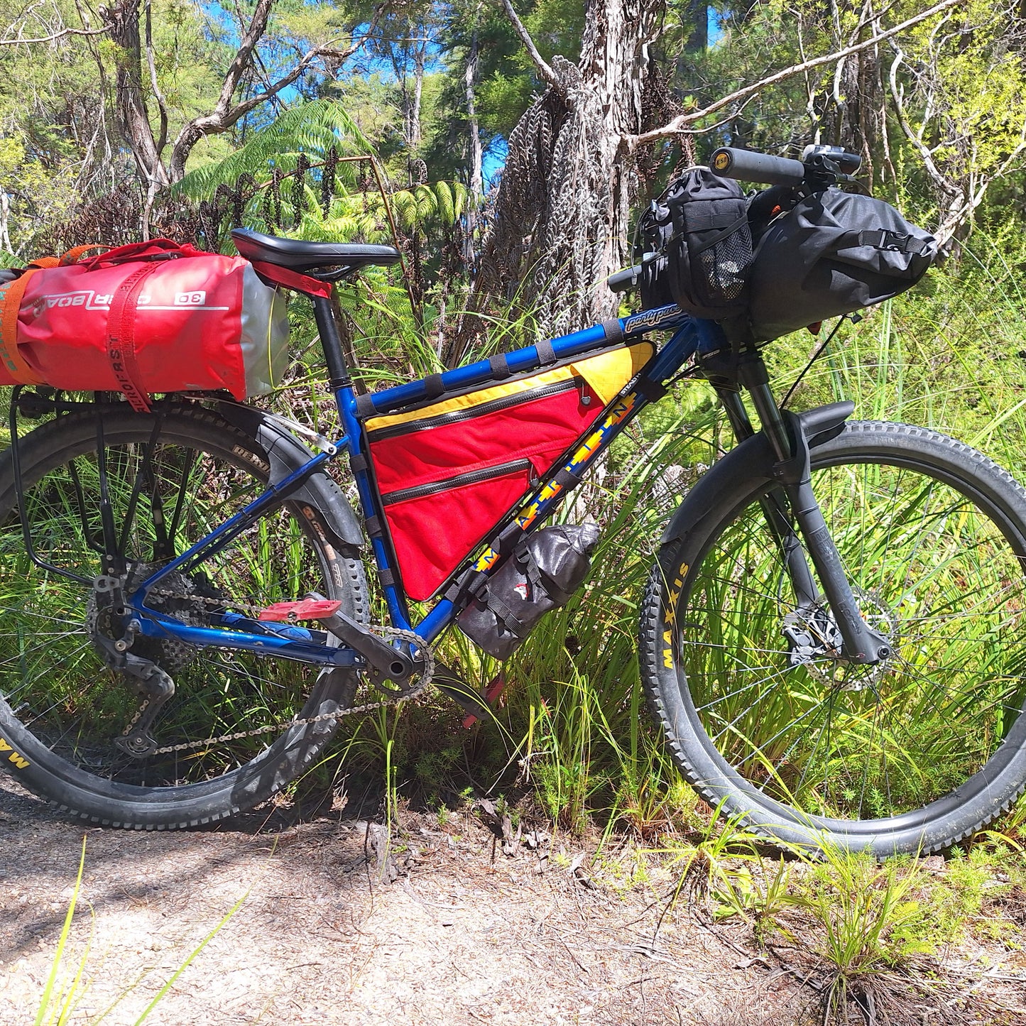 Marin Pine Mountain custom double zip frame bag in red and yellow on trail made by Stealth Wellington NZ