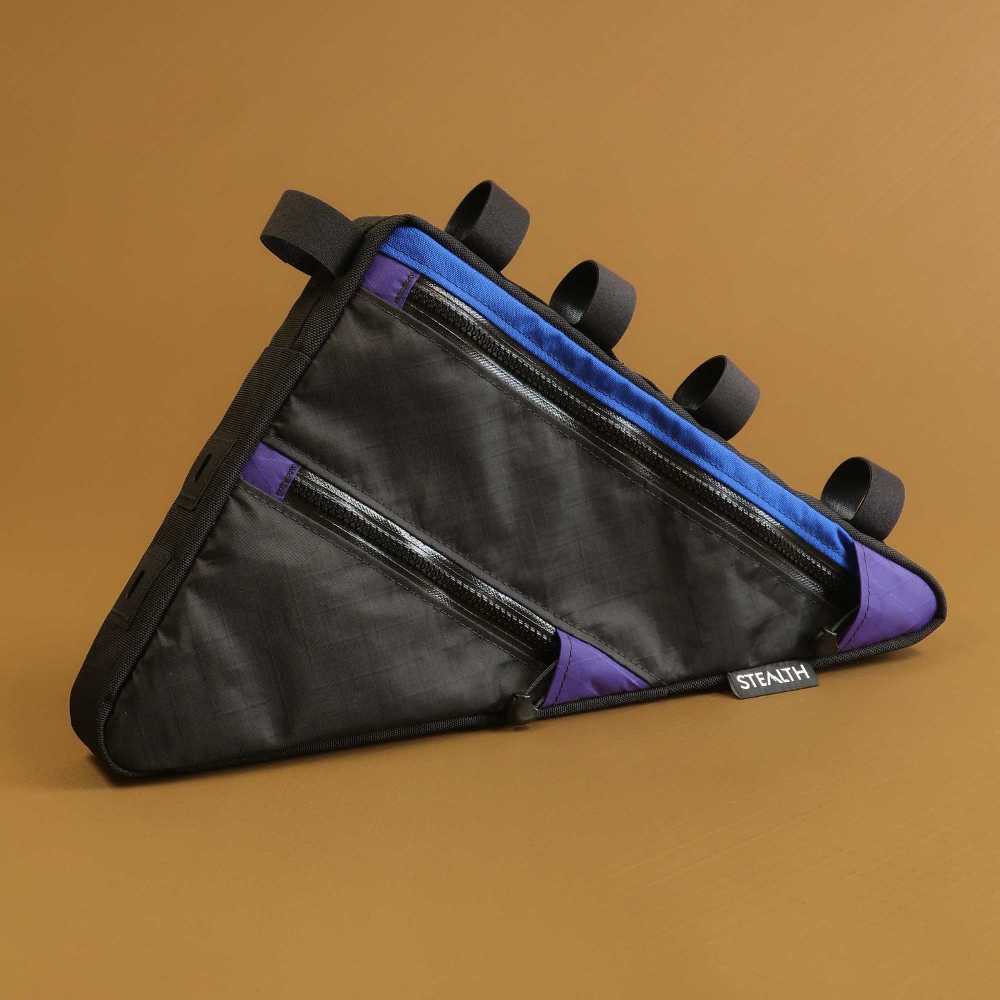 Custom frame bag in black Ecopak with blue and purple accents and bolt-on attachment made by Stealth Wellington NZ