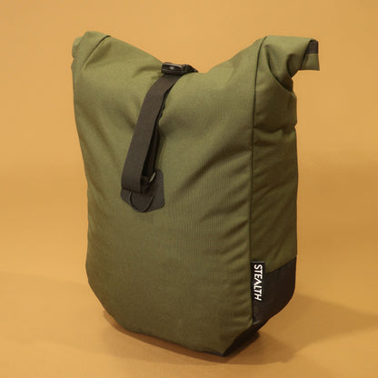 Olive Cordura mountain bike pannier with a roll top closure and adjustable attachment straps for bikepacking.