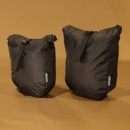 8L and 10L black panniers side by side from the front, showing the size difference when fully packed