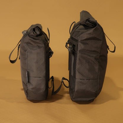 8L and 10L black panniers side by side in profile, showing the difference in depth and height between the two sizes