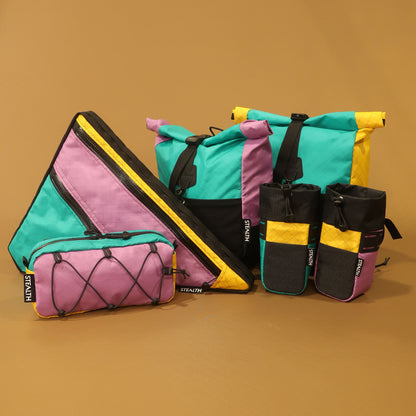 Multicolour handmade bikepacking bags, including a double zip full frame bag with secure attachment points, crafted in New Zealand for cyclists and adventurers.