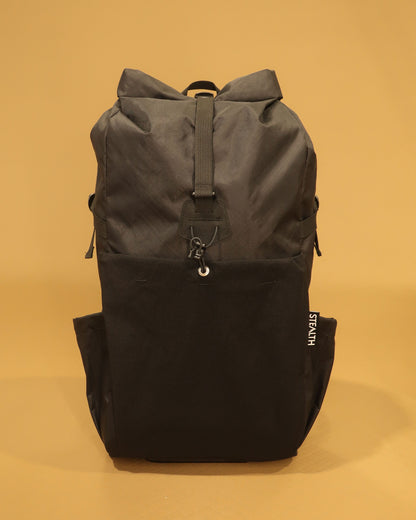 Rata 25 black roll-top daypack front view with ultrastretch pocket and compression strap made by Stealth Wellington NZ