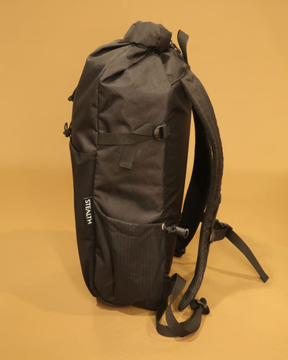 Rata 25 roll-top backpack side profile in black with ultragrid bottle pocket made by Stealth Wellington NZ