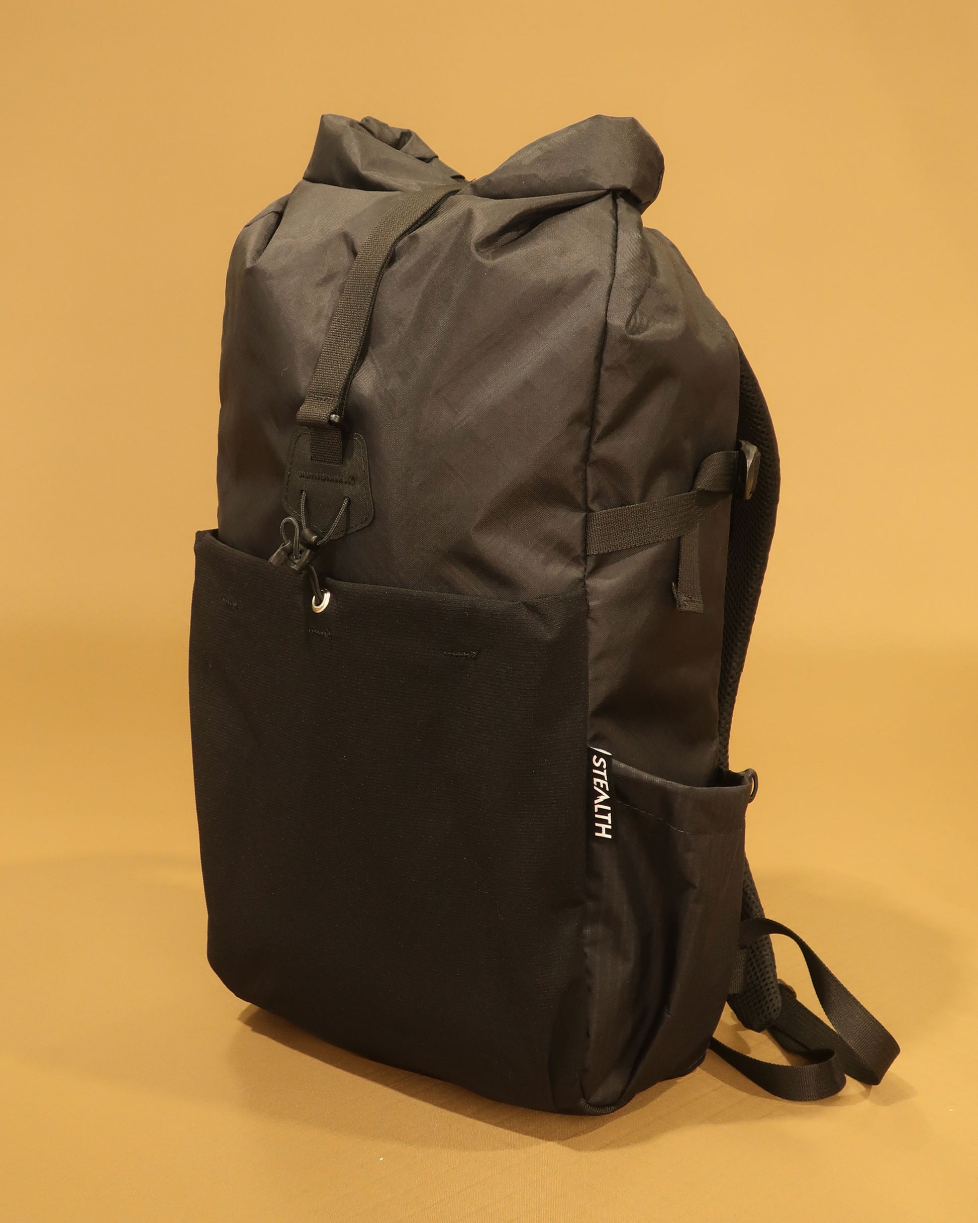 Rata 25 roll-top backpack in black with ultrastretch front pocket and ultragrid side pocket made by Stealth Wellington NZ