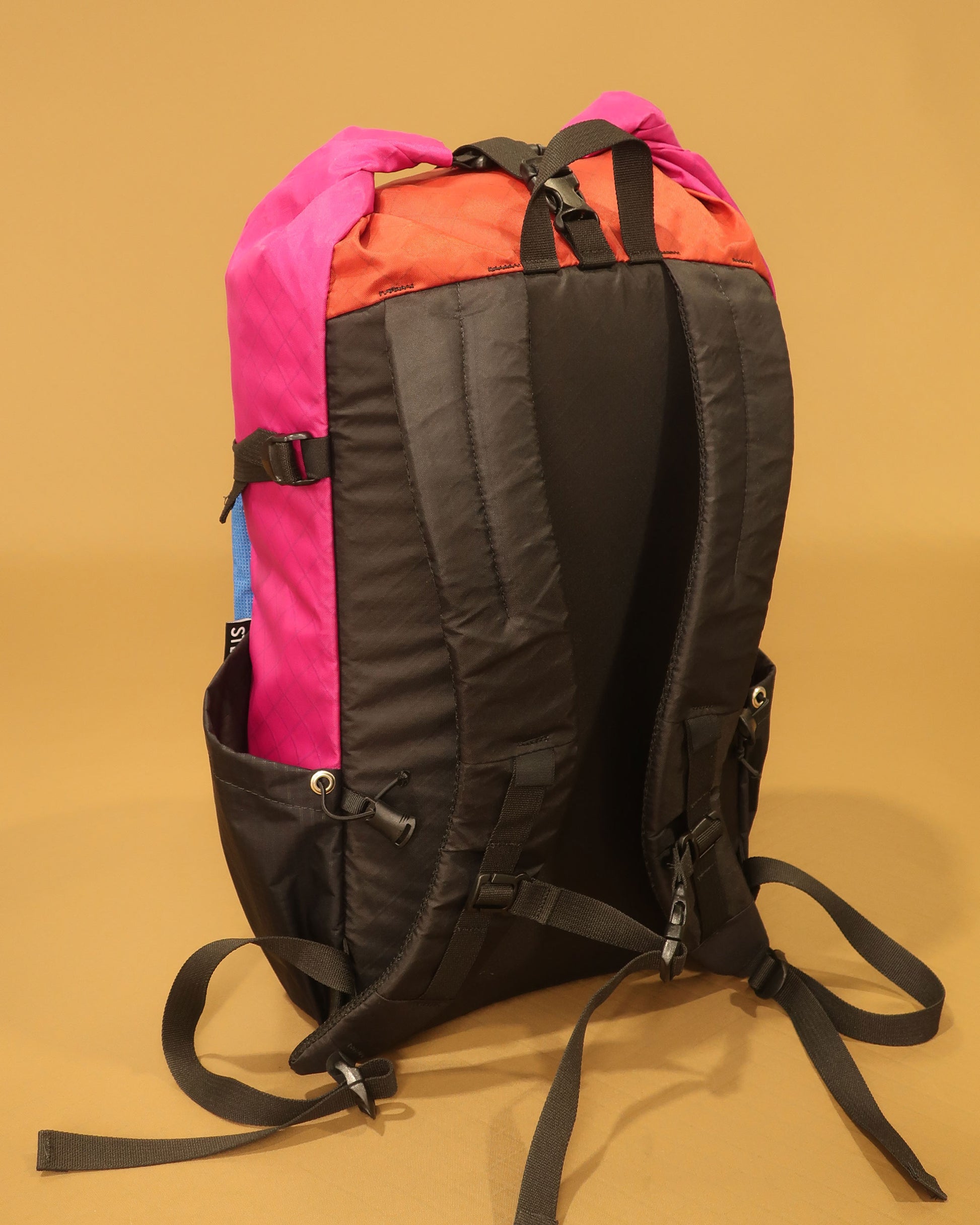 Rata 25 hiking backpack back panel in brick red and fuchsia showing padded shoulder straps made by Stealth Wellington NZ