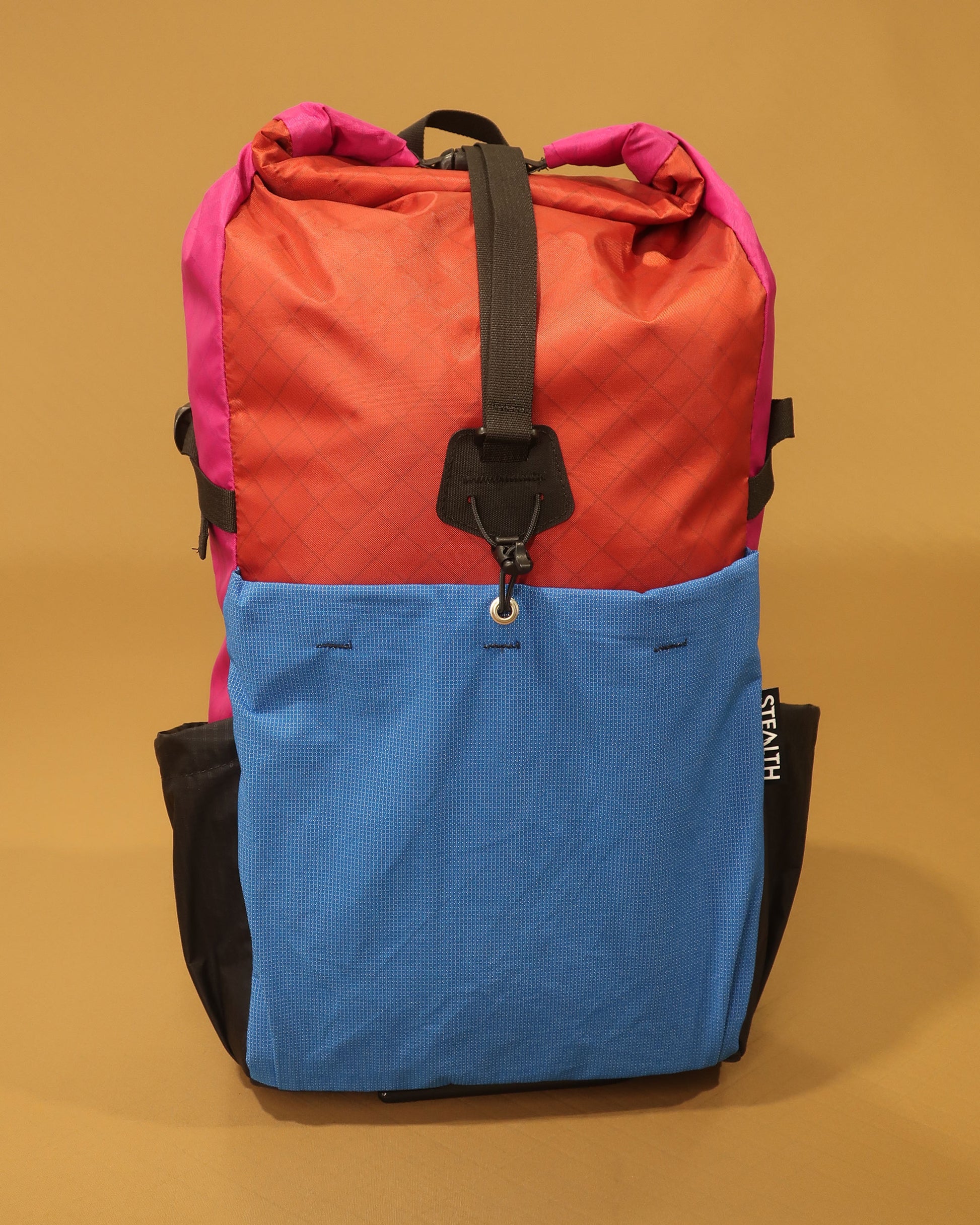 Rata 25 backpack in brick red and fuchsia with blue ultrastretch front pocket made by Stealth Wellington NZ