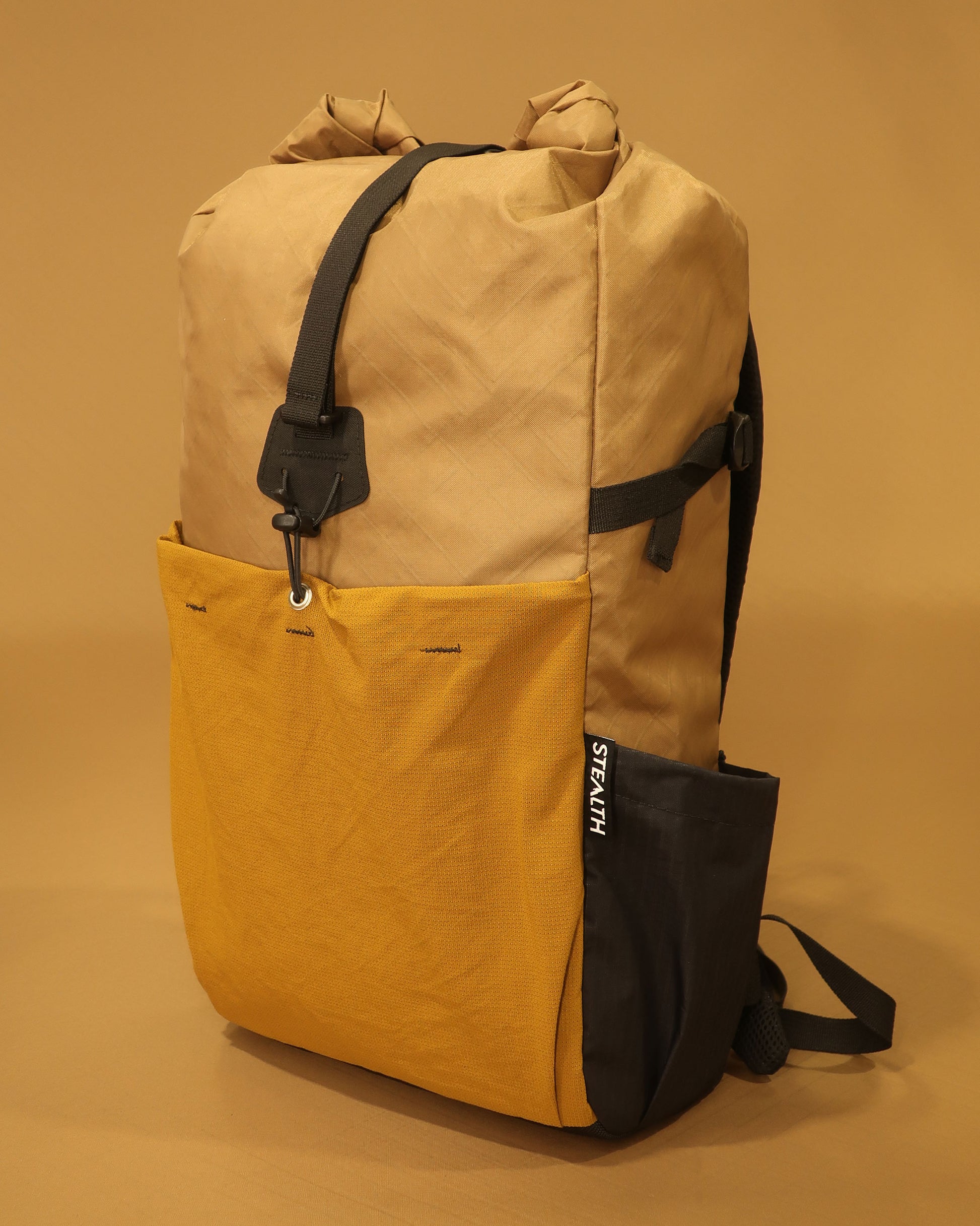 Rata 25 roll-top backpack in coyote with mustard yellow ultrastretch front pocket made by Stealth Wellington NZ
