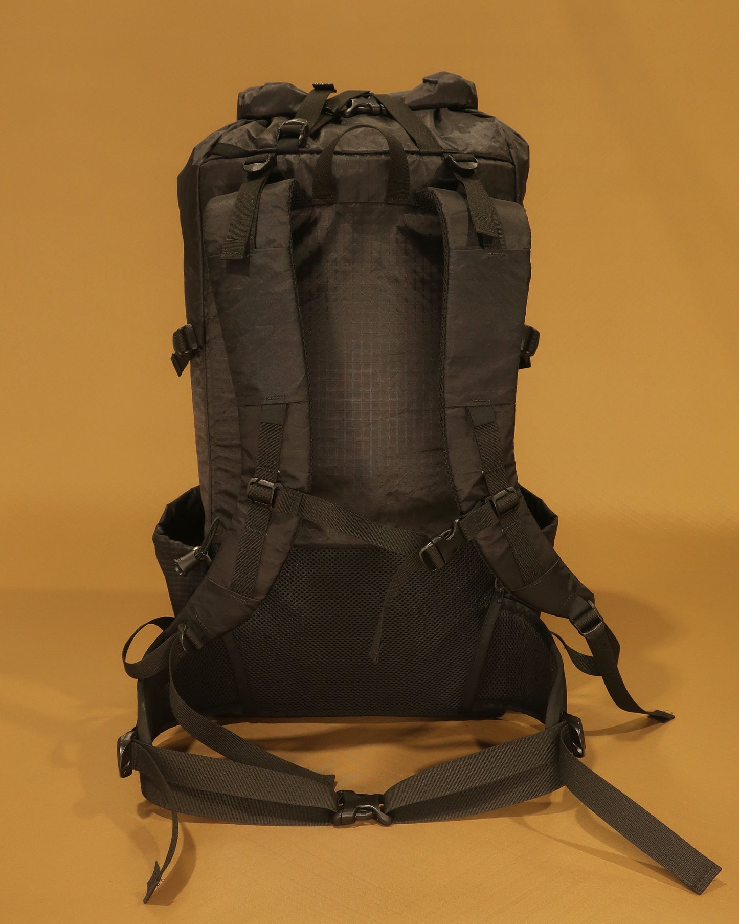 Rata 40 black tramping pack rear view showing padded back panel, spacer mesh and hip belt, made by Stealth Wellington NZ