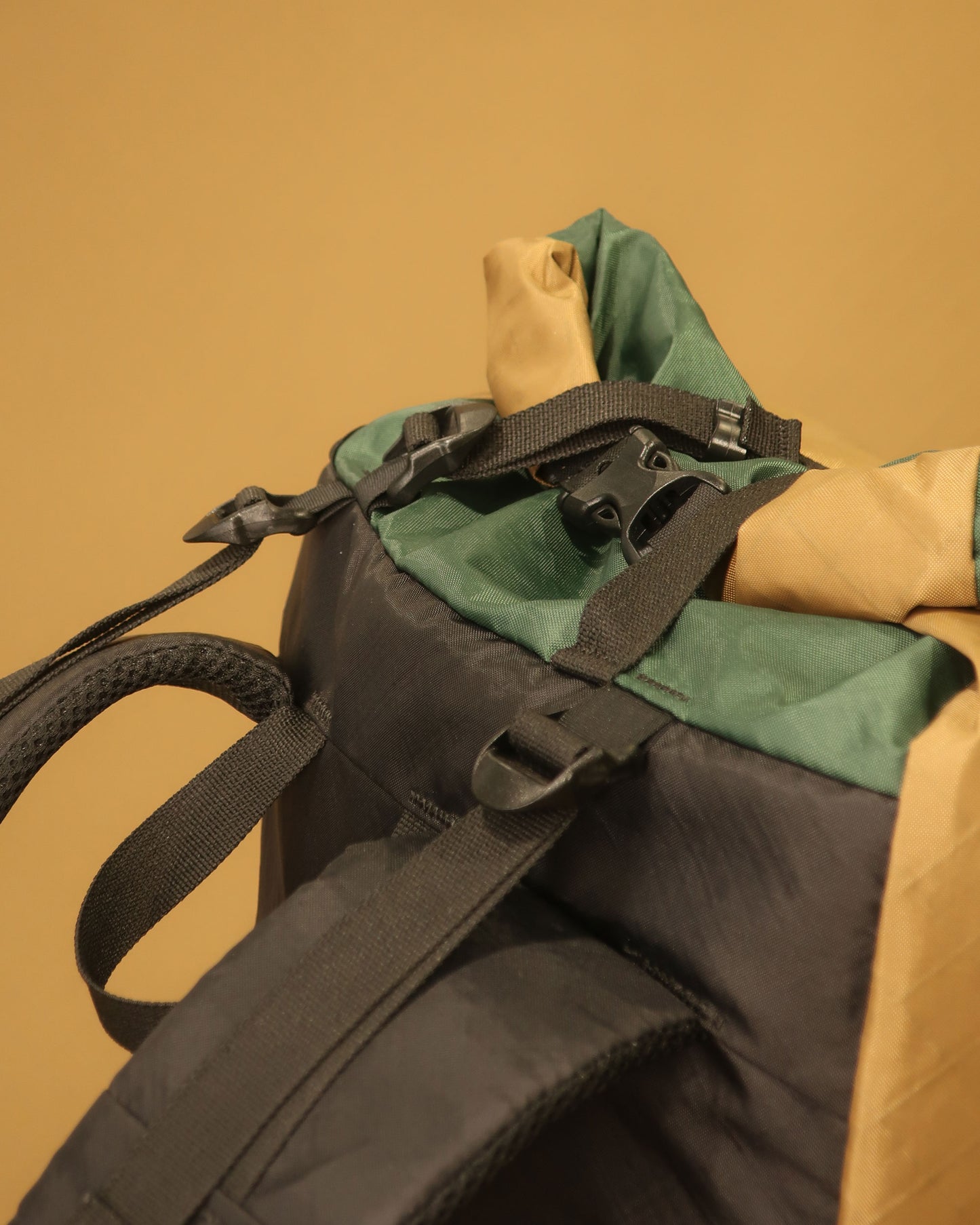 Rata 40 coyote tan pack top detail showing Y-strap, load lifters and roll-top closure, made by Stealth Wellington NZ
