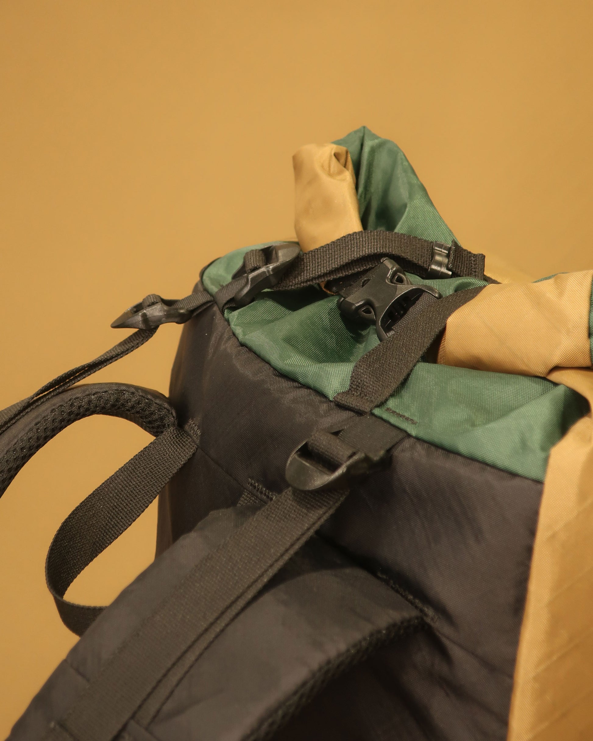 Rata 40 coyote tan pack top detail showing Y-strap, load lifters and roll-top closure, made by Stealth Wellington NZ
