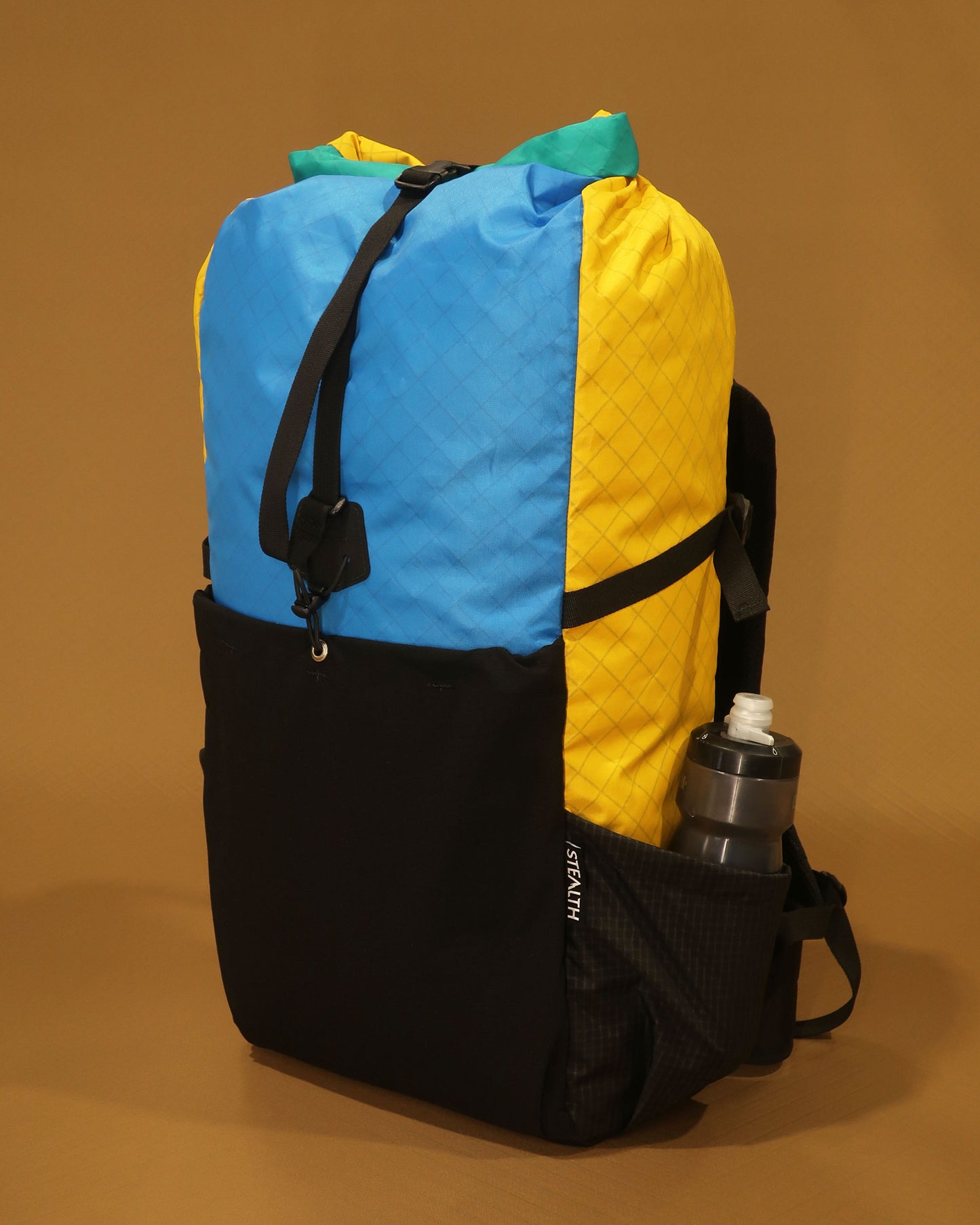 Rata 40 tramping pack with water bottle in Ultragrid side pocket, multicolour EPX200 version, made by Stealth Wellington NZ