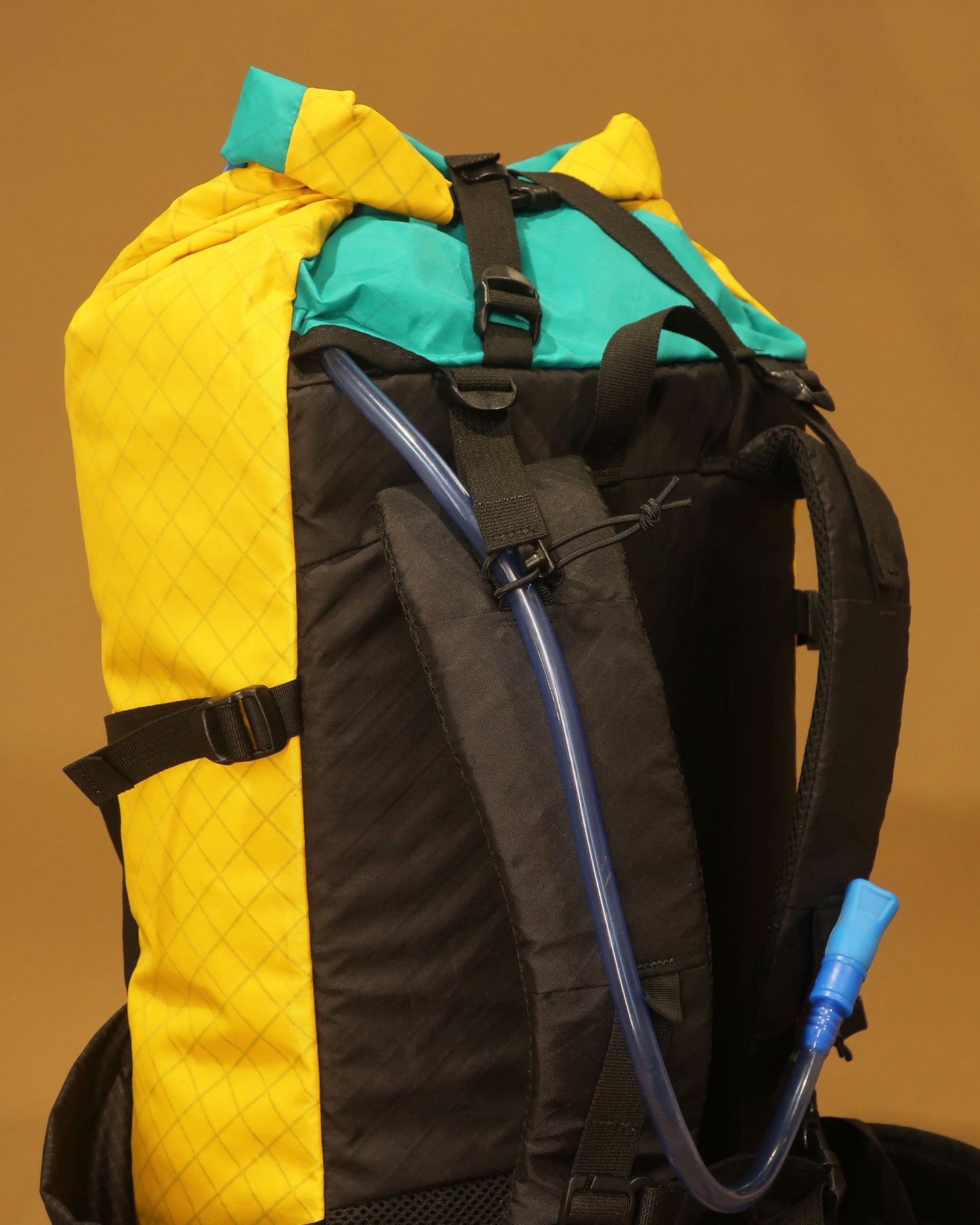 Rata 40 tramping pack shoulder strap showing hydration tube port with bladder tube fitted, made by Stealth Wellington NZ