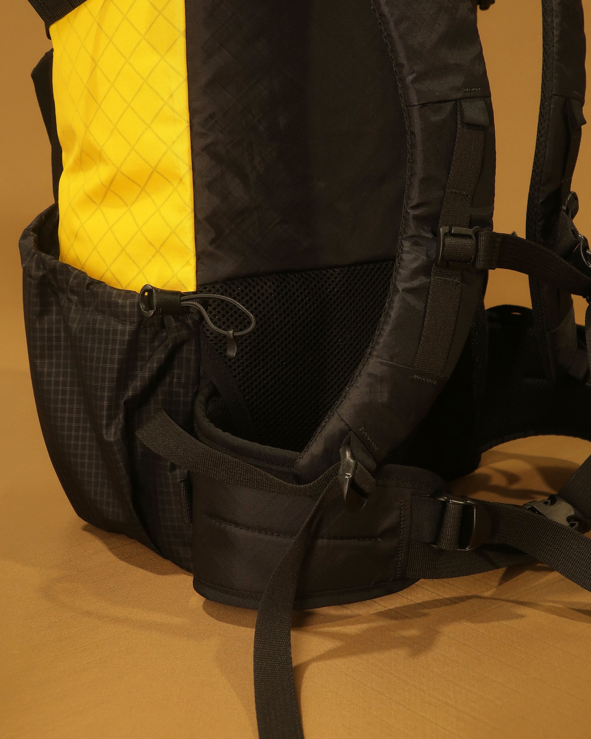 40L tramping pack hip belt detail showing padded wings and adjustment straps, made by Stealth Wellington NZ