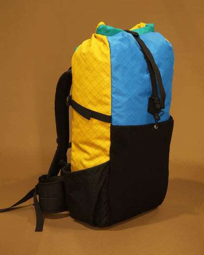 Multicolour tramping pack showing ultra-stretch front pocket and Ultragrid side bottle pockets, made by Stealth Wellington NZ
