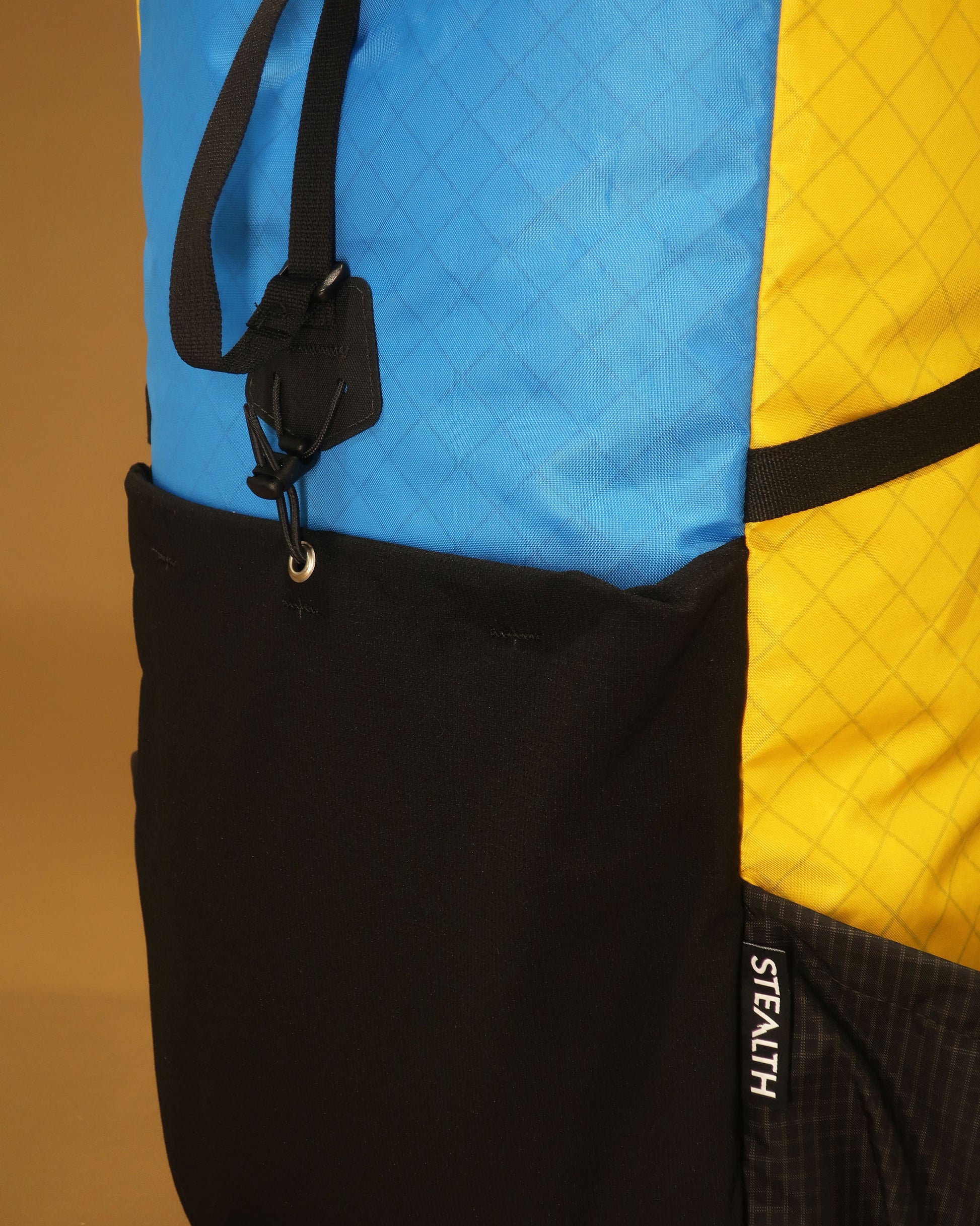 ramping pack ultra-stretch front pocket and compression strap hook detail, multicolour version, made by Stealth Wellington NZ