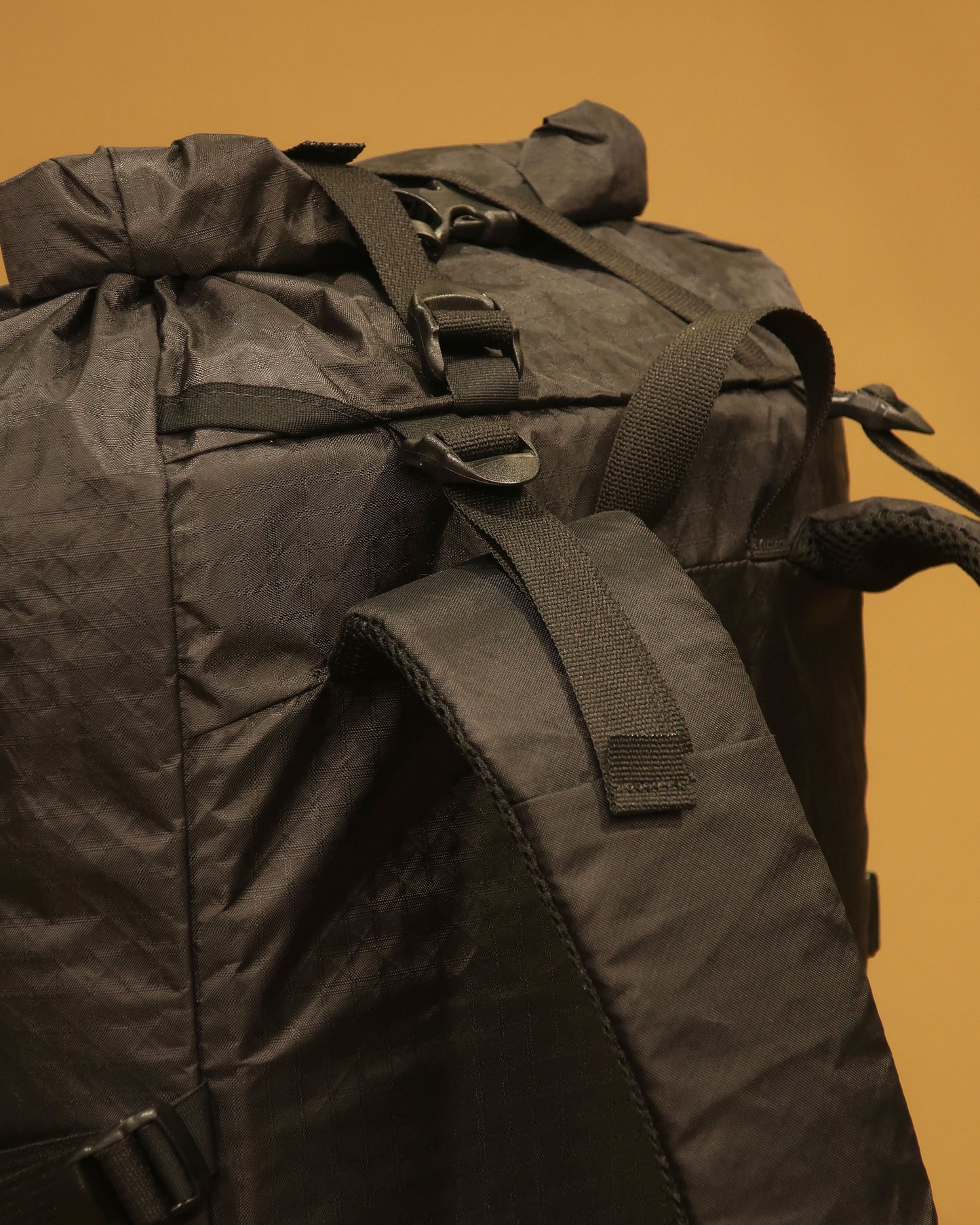 Rata 40 tramping pack shoulder strap detail showing load lifters and hydration tube port, made by Stealth Wellington NZ
