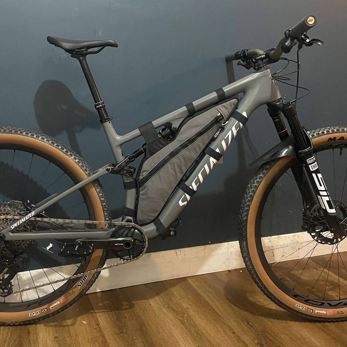 Grey custom full suspension frame bag fitted inside a Specialized Epic 8 frame with adjustable straps and water resistant zip. Made in New Zealand