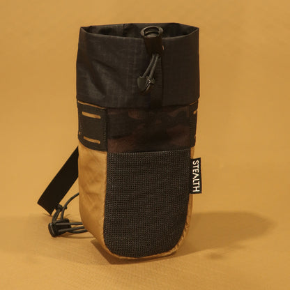 Stem Pouch V2 Coyote pouch with a black camouflage body, front mesh pocket, and attachment straps.