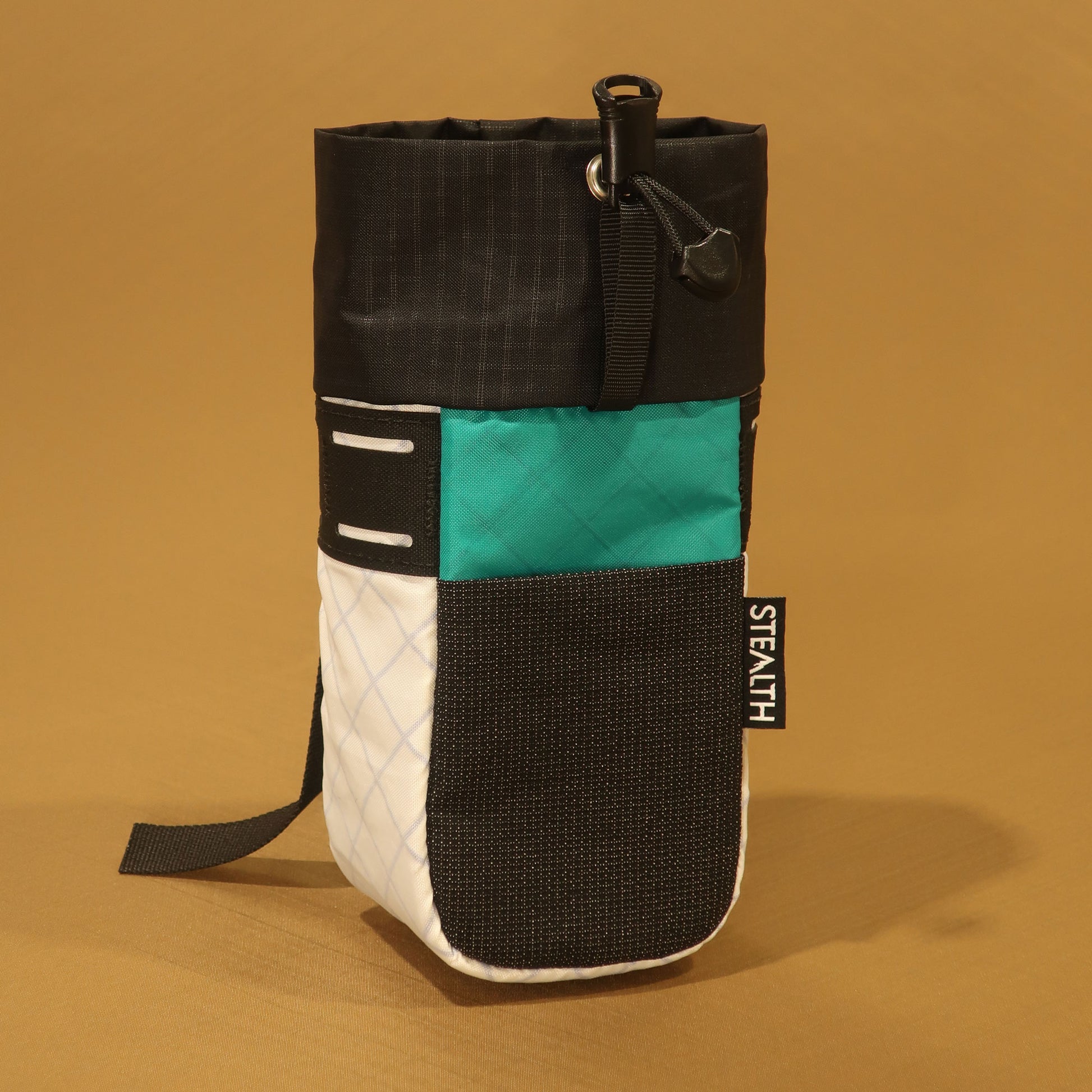 Stem Pouch V2 LS42 pouch in black, teal and white with camlock webbing strap and stretch front pockets.