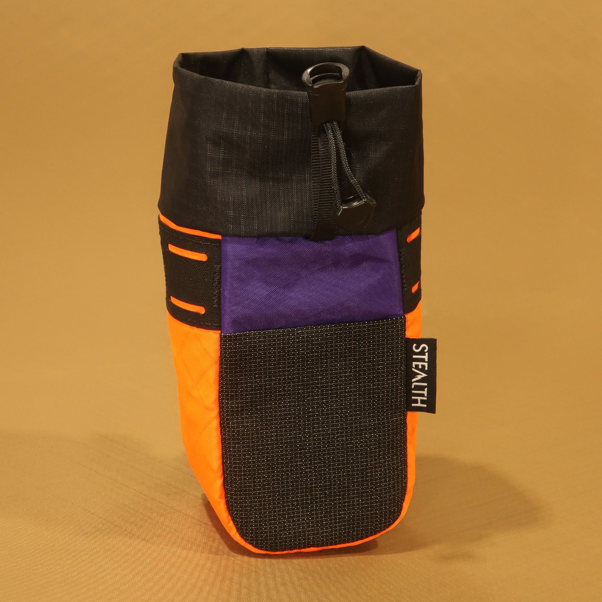 Stem Pouch V2 orange and purple pouch with a black mesh front pocket and attachment strap