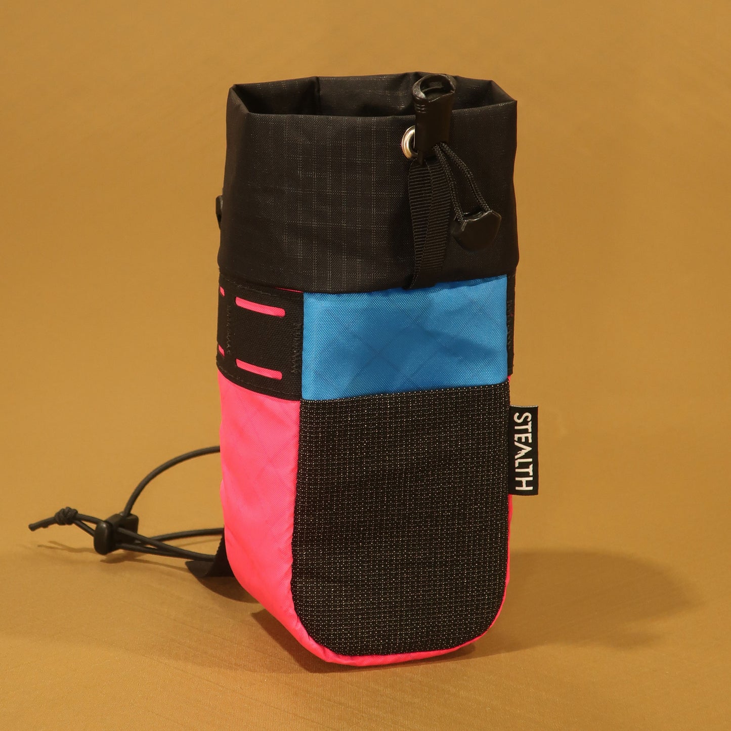 Stem Pouch V2 Pink pouch with a bright blue panel, black mesh pocket, and attachment straps.