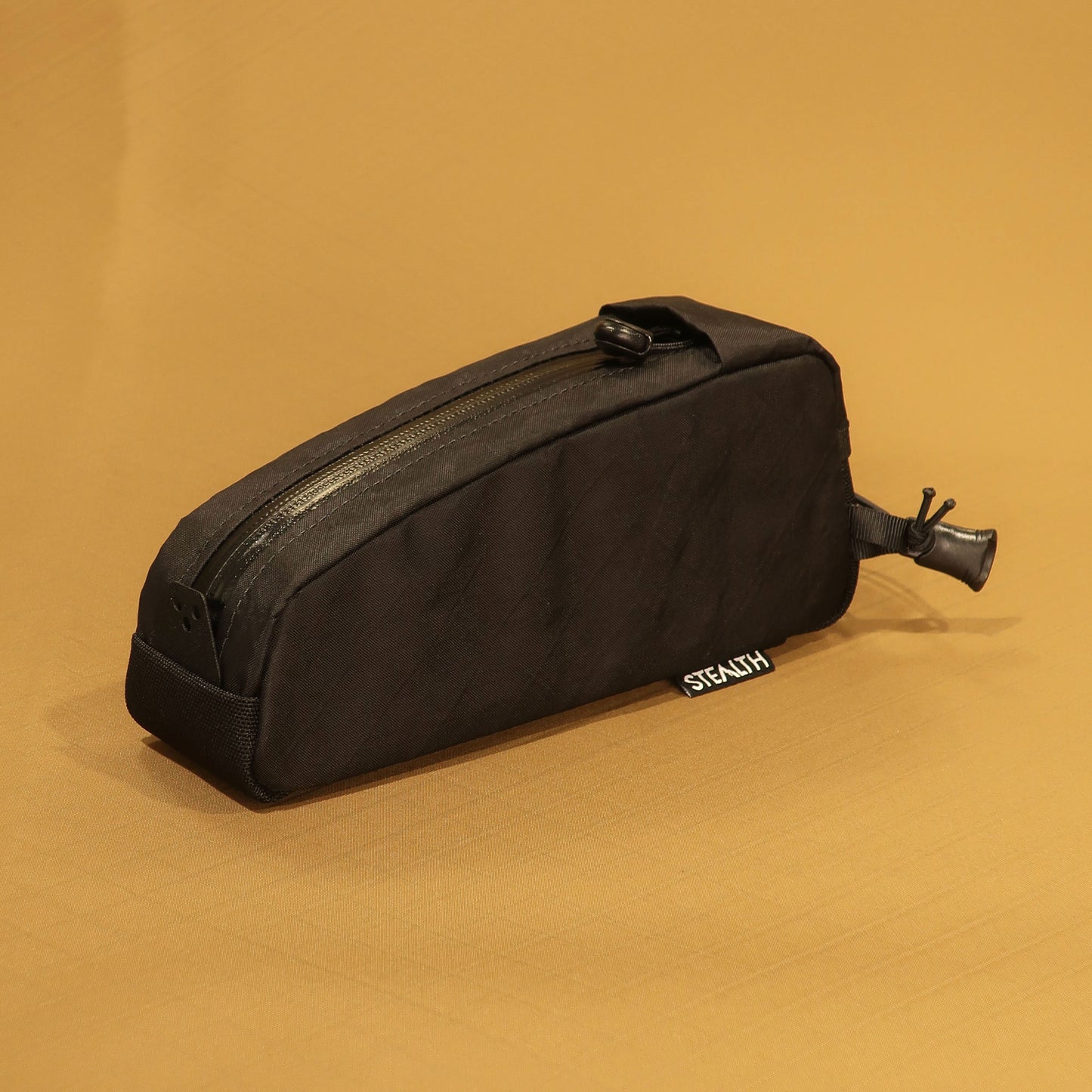 Top Loader bolt on top tube bag in black side profile showing wedge shape and zip pull made by Stealth Wellington NZ