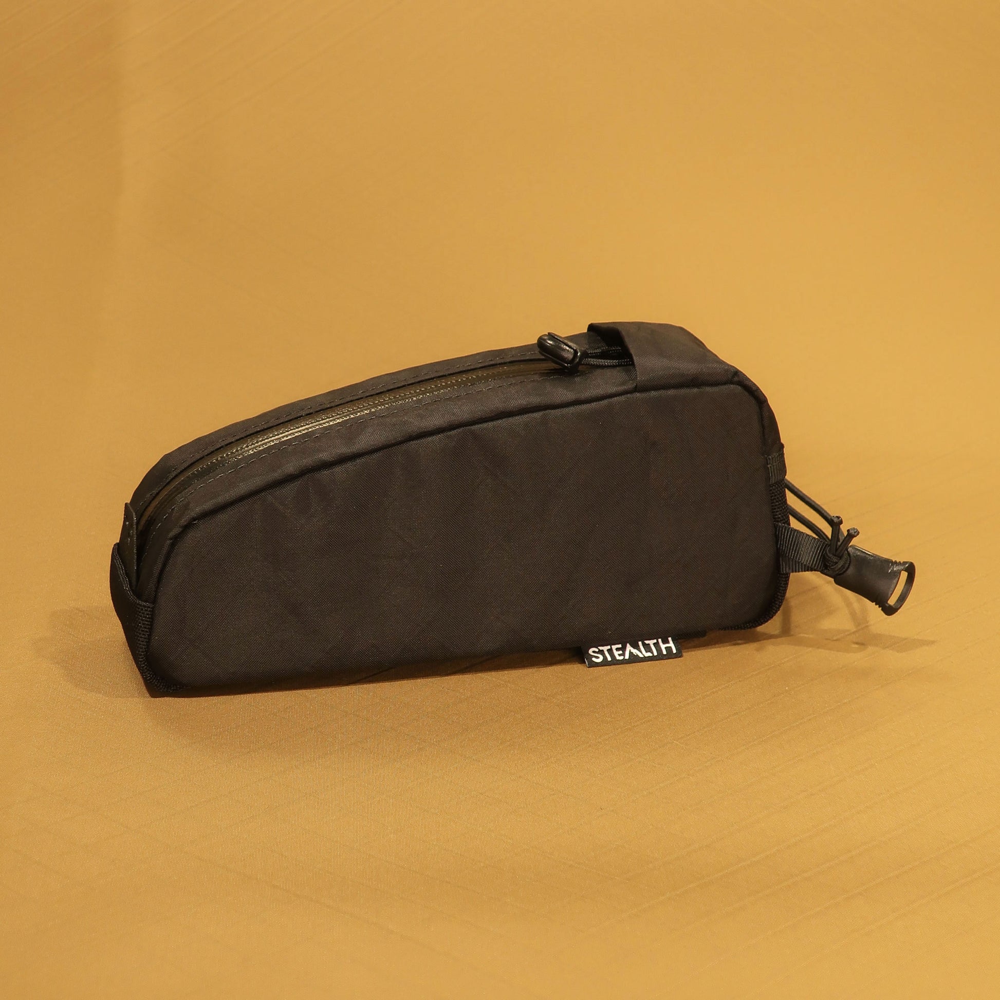 Bolt on top tube bag in black EPX200 showing cable port and bungee attachment loop made by Stealth Wellington NZ